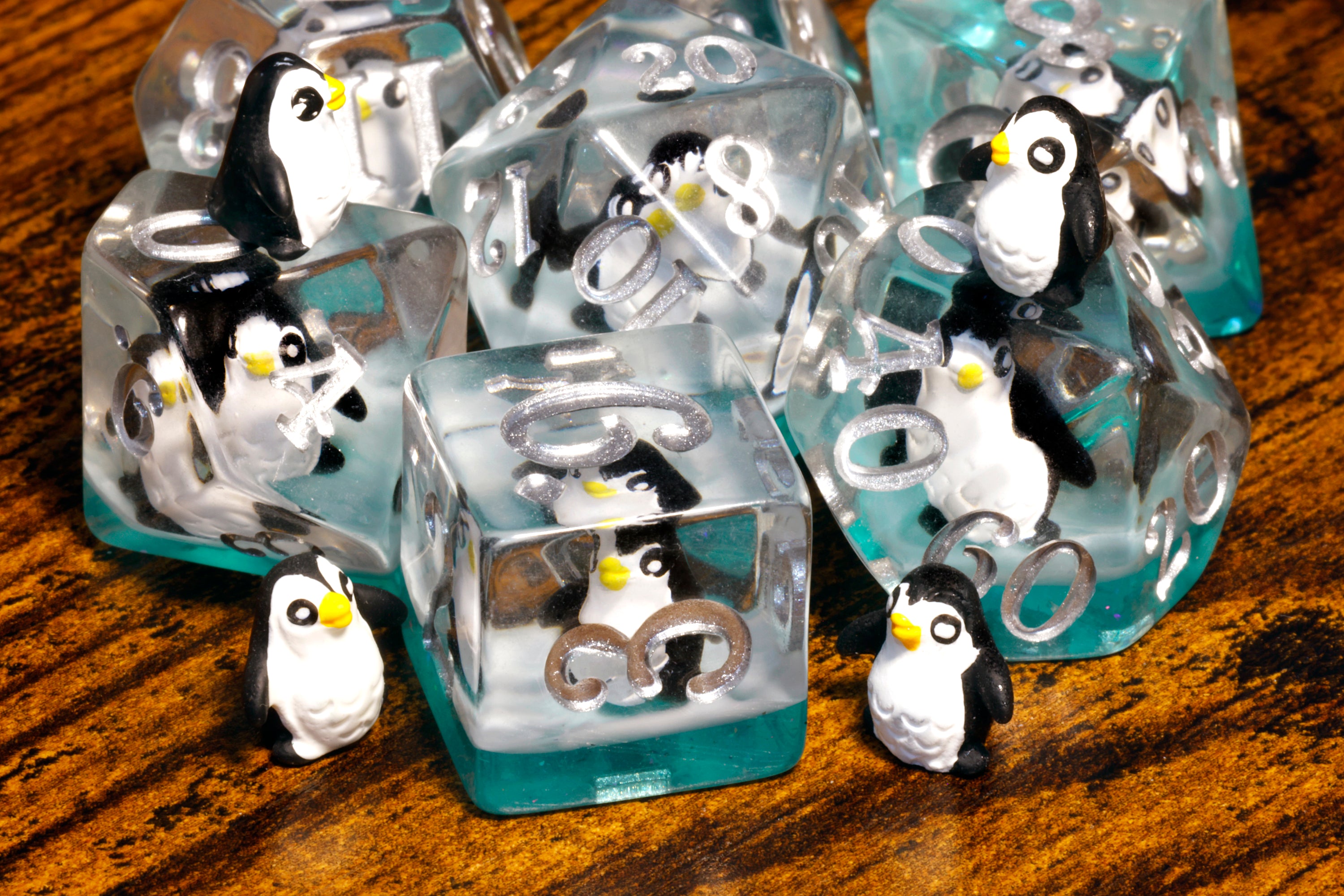 a group of penguin figurines sitting on top of ice blocks