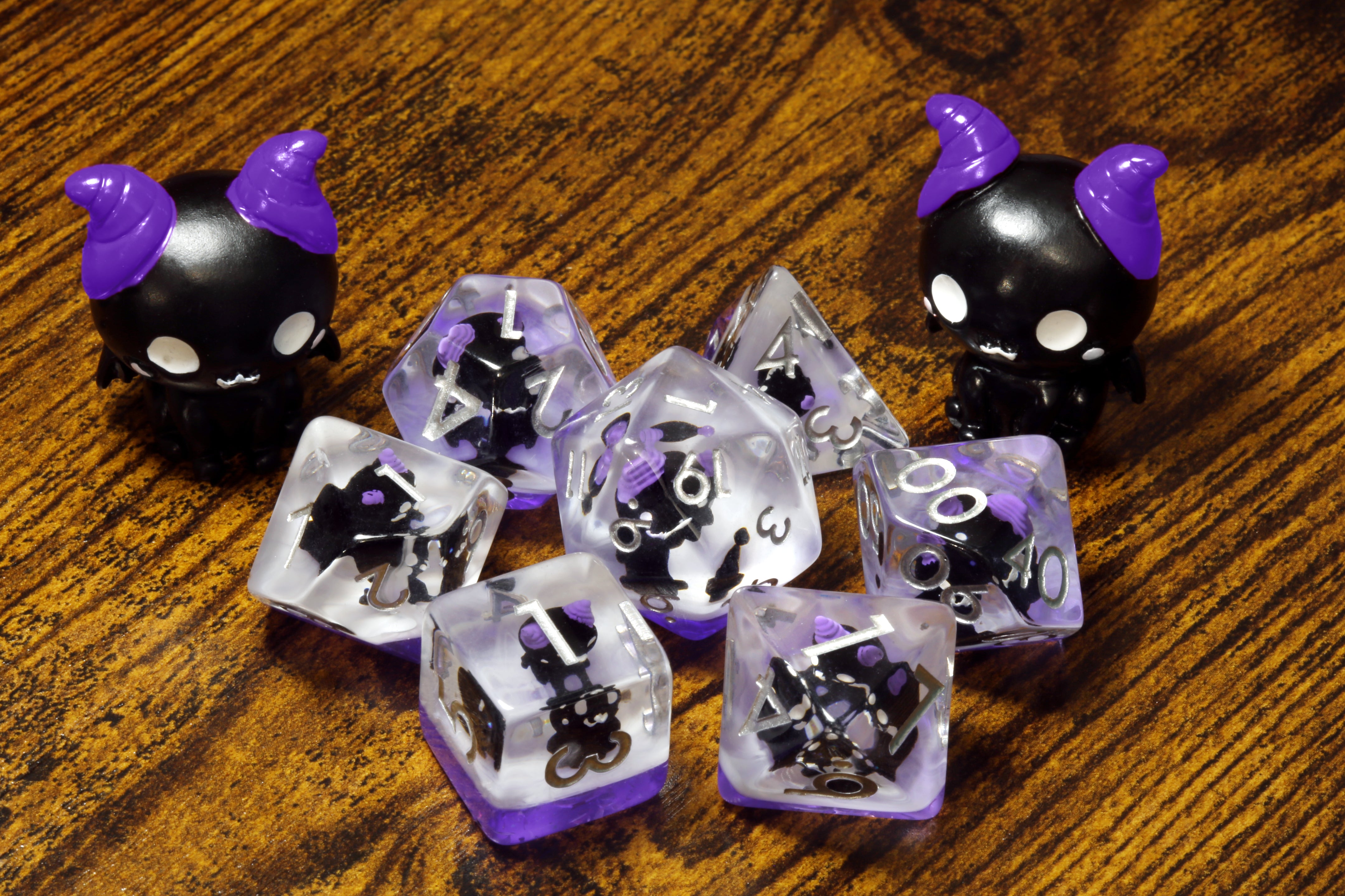 Cats of doom dice set - Dice set with winged cats on an purple layer - The Wizard's Vault