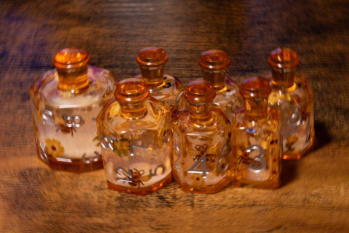 Honey Meadow 7-Piece Liquid Core Potion Dice Set – Amber with Bee & Wildflower Pattern