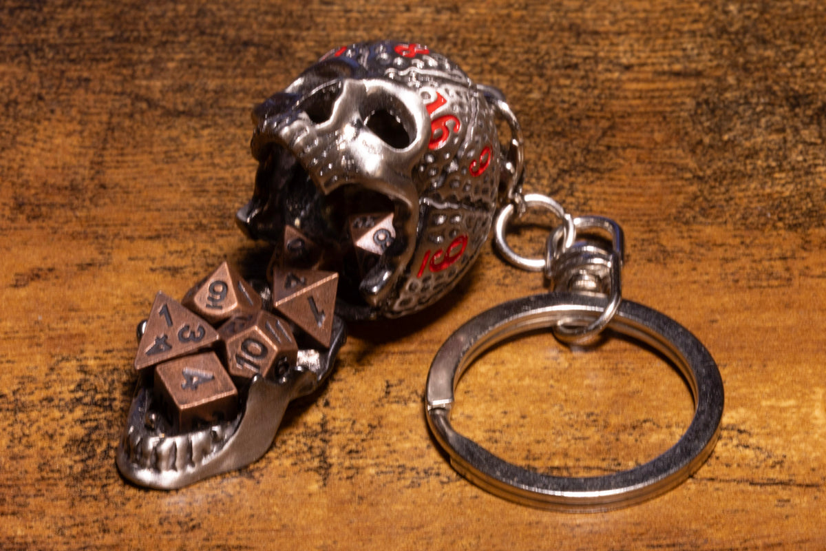 Skull Dice Keeper Keychain – Metal Skull with Miniature 7-Piece Copper Dice Set