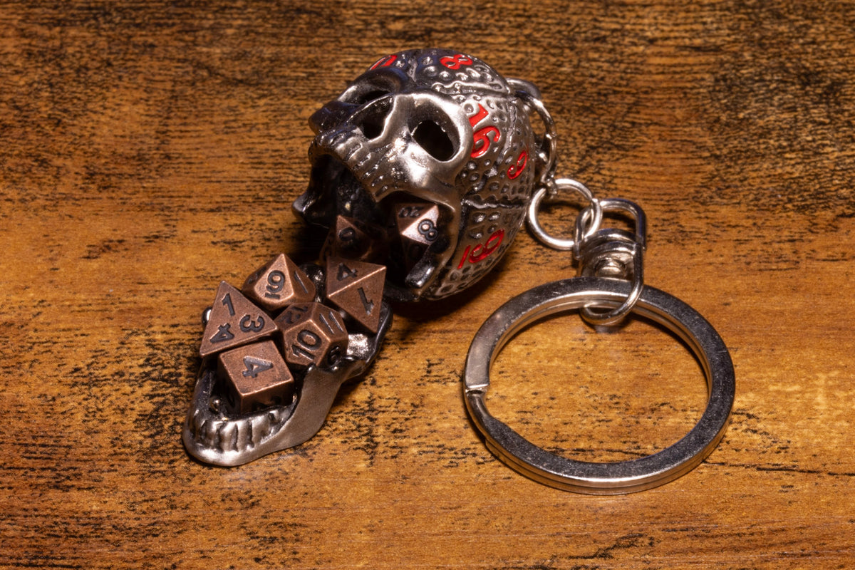 Skull Dice Keeper Keychain – Metal Skull with Miniature 7-Piece Copper Dice Set