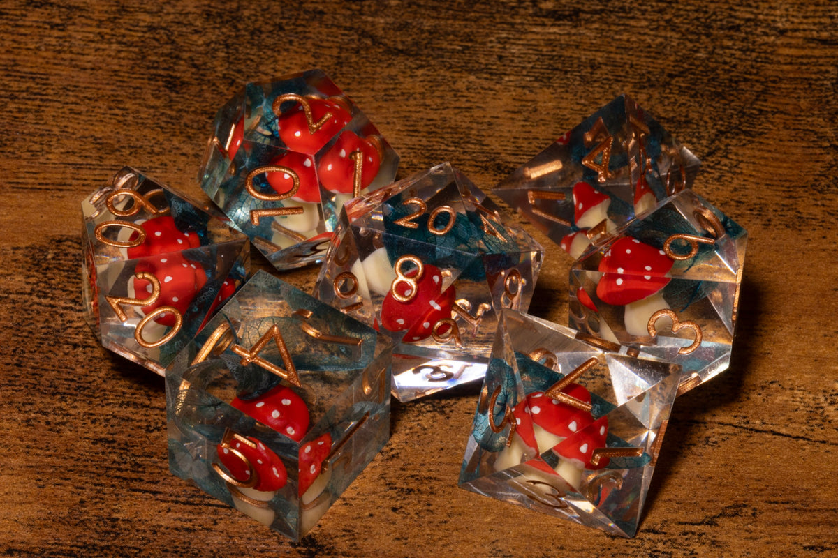 Toadstool Hollow 7-Piece Sharp Edge Dice Set – Clear with Red Mushroom & Moss Inclusions