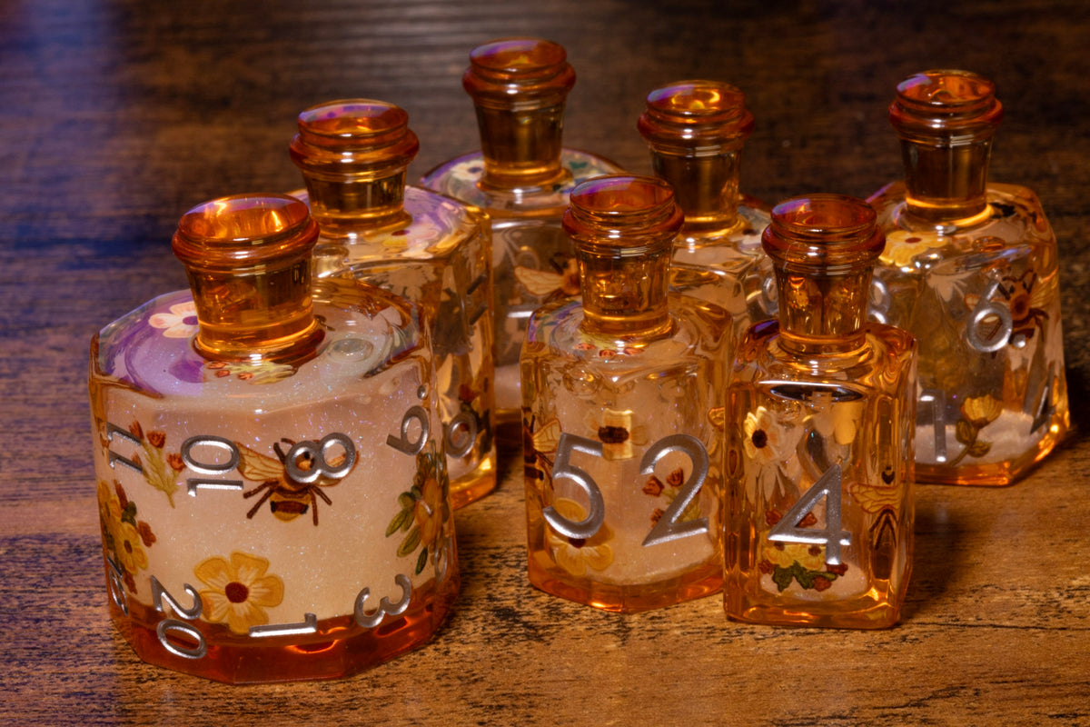 Honey Meadow 7-Piece Liquid Core Potion Dice Set – Amber with Bee & Wildflower Pattern