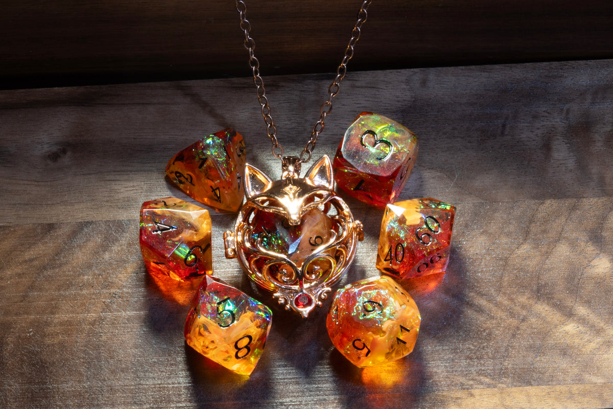 Amber Opal dice set with the fox D20 holder pendant in a copper finish on wood