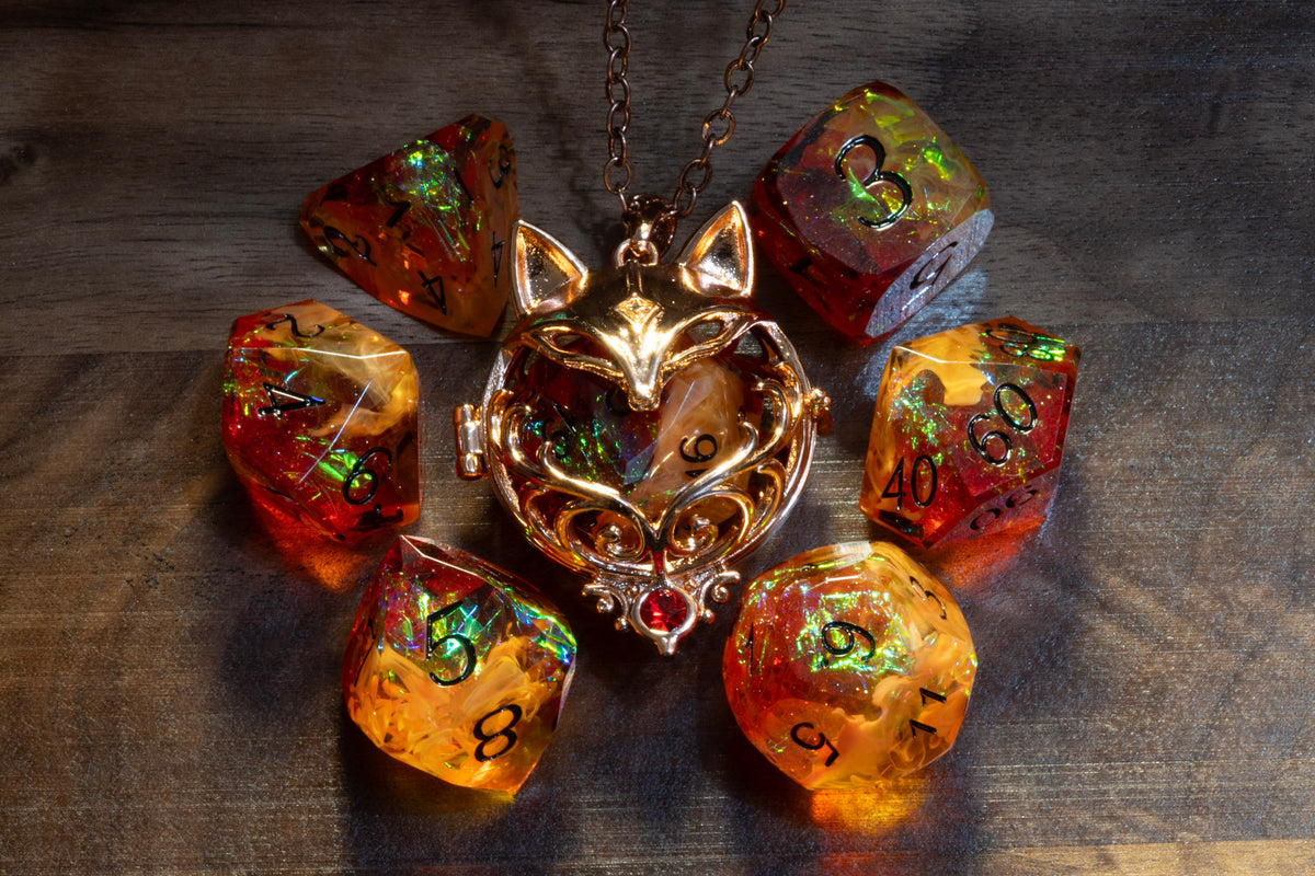 Fox pendant in a copper finish with the Amber Opal dice set on wood