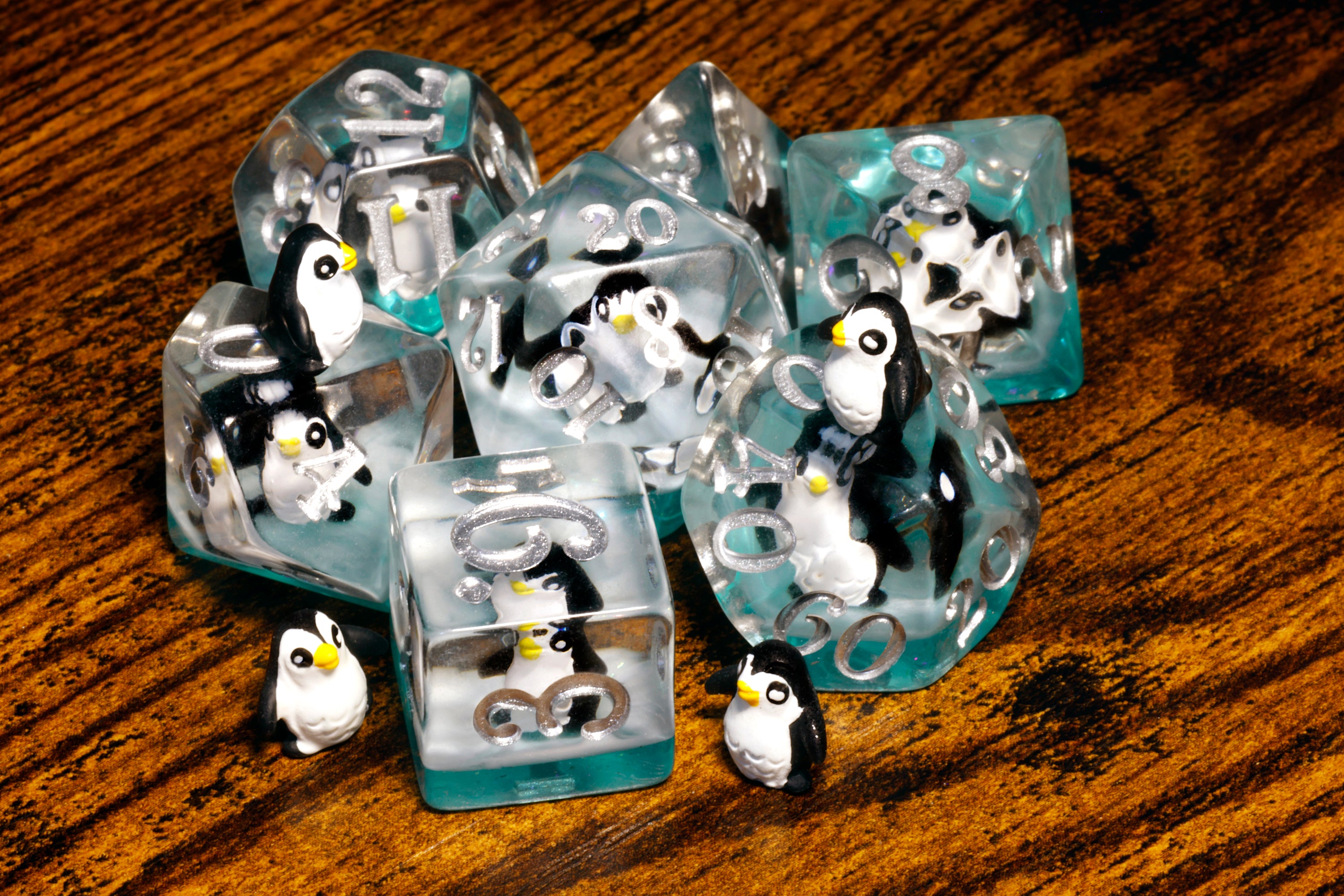 a group of penguins sitting on top of ice blocks