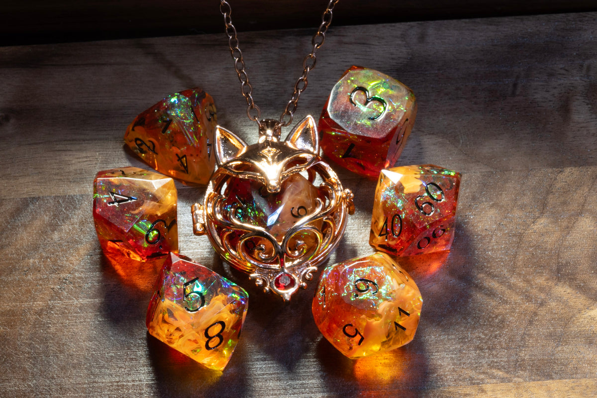 Fox pendant in a copper finish with the Amber Opal dice set on wood