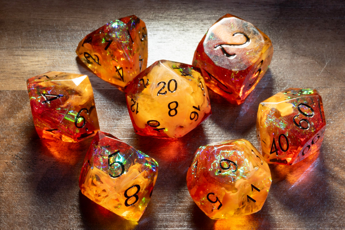 Amber Opal sharp-edge dice set in amber and orange-red resin with holographic foil on wood