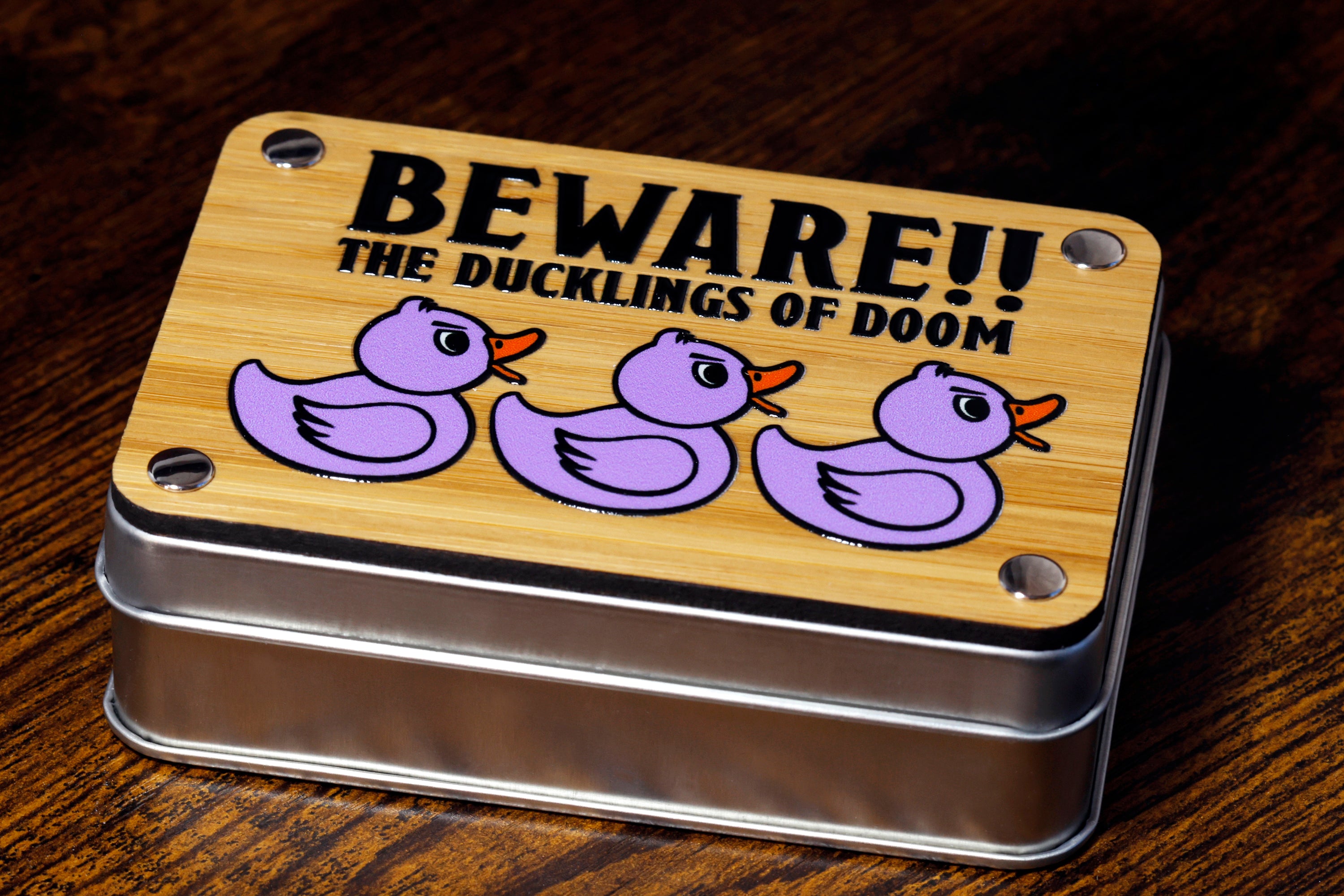 a metal tin with a picture of three rubber ducks on it