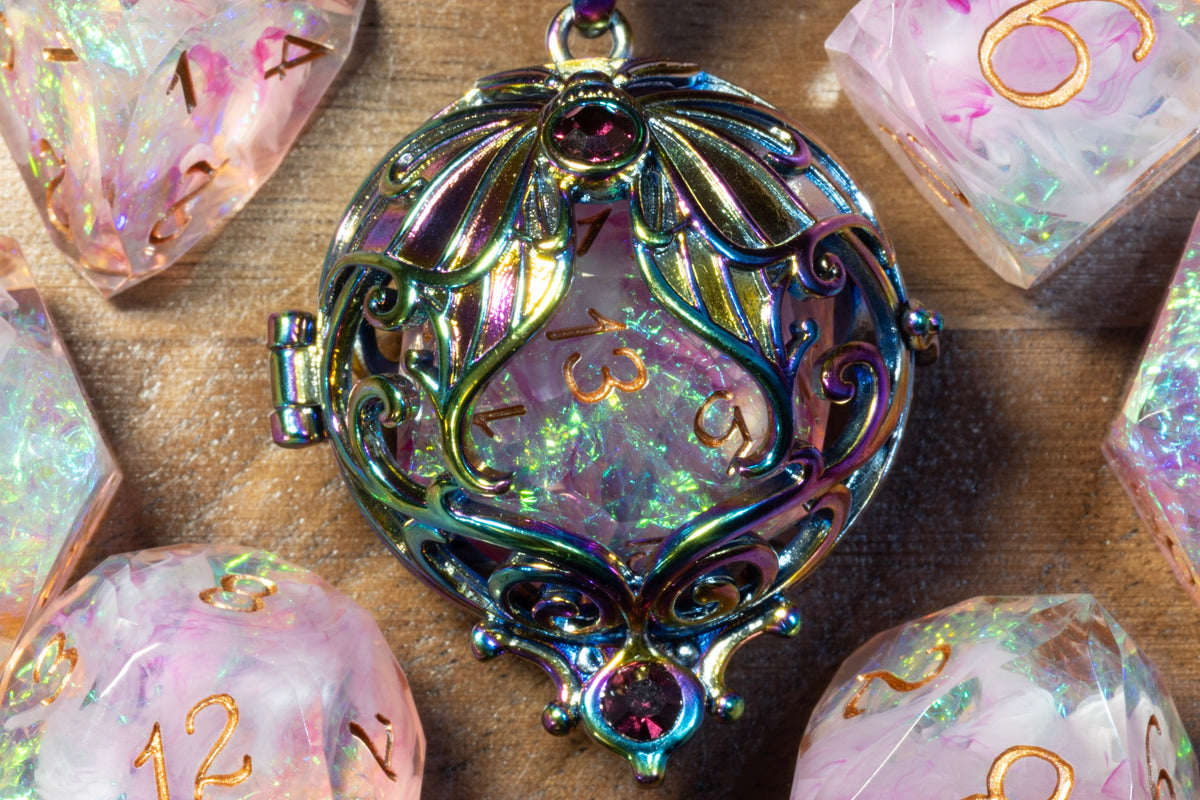 Close-up of the lunar moth pendant in a rainbow finish holding a Blush Opal D20