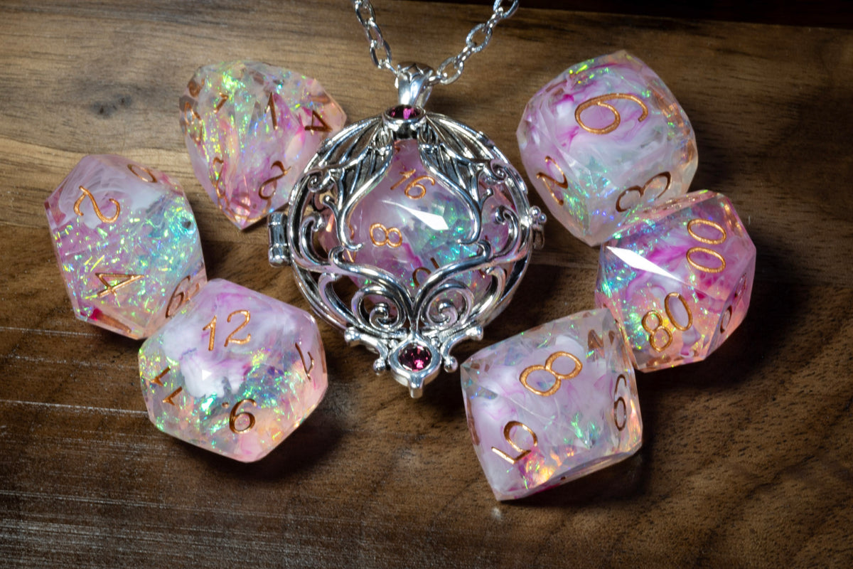 Lunar moth pendant in a silver finish with the Blush Opal dice set on wood