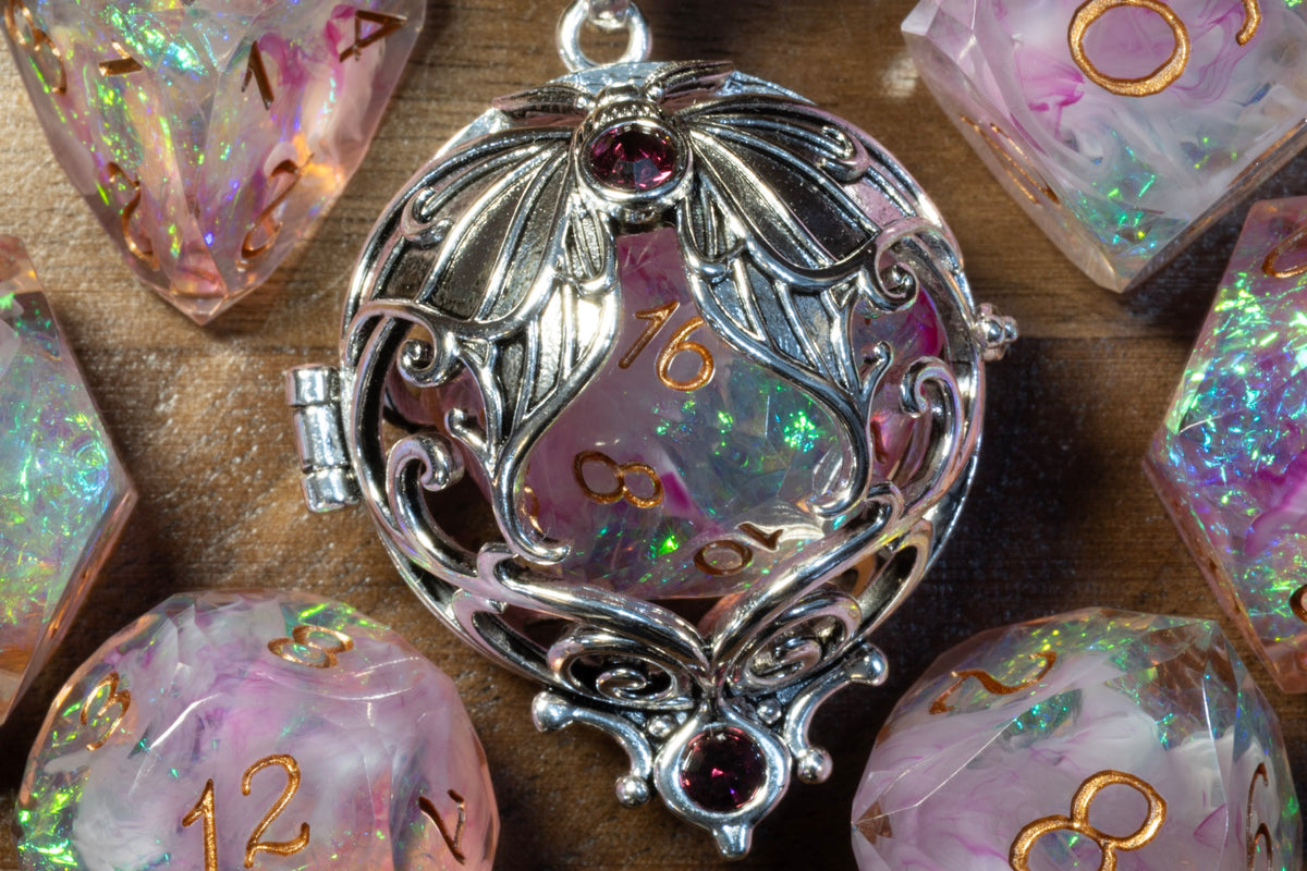 Close-up of the lunar moth pendant in a silver finish holding a Blush Opal D20