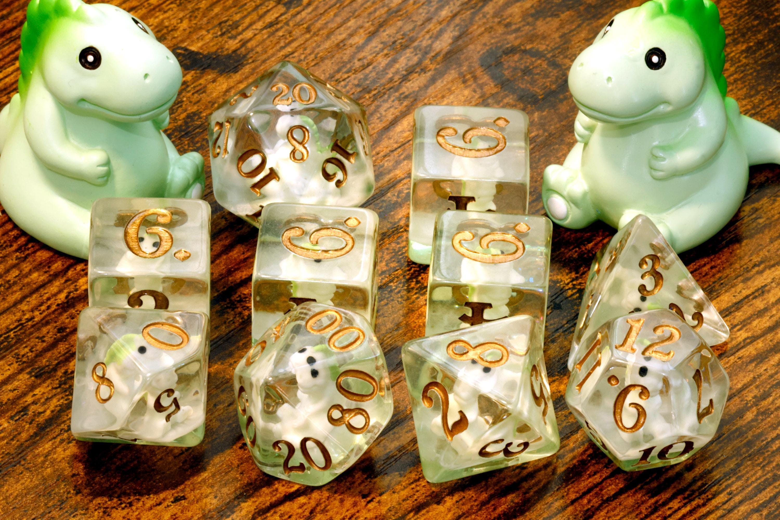 T-Rex dice set with miniature green dinosaurs and gold numbers