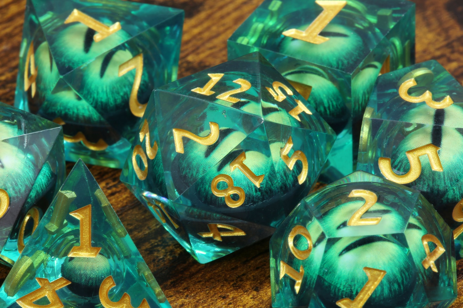 Basilisk Gaze dice set - Liquid Core sharp edge dice with green moving eyes - The Wizard's Vault