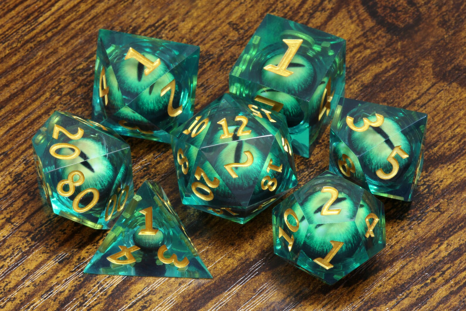 Basilisk Gaze dice set - Liquid Core sharp edge dice with green moving eyes - The Wizard's Vault