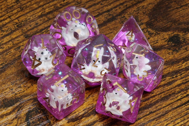Unicorn dice set - Dice set with a unicorn inside on a pink layer - The Wizard's Vault