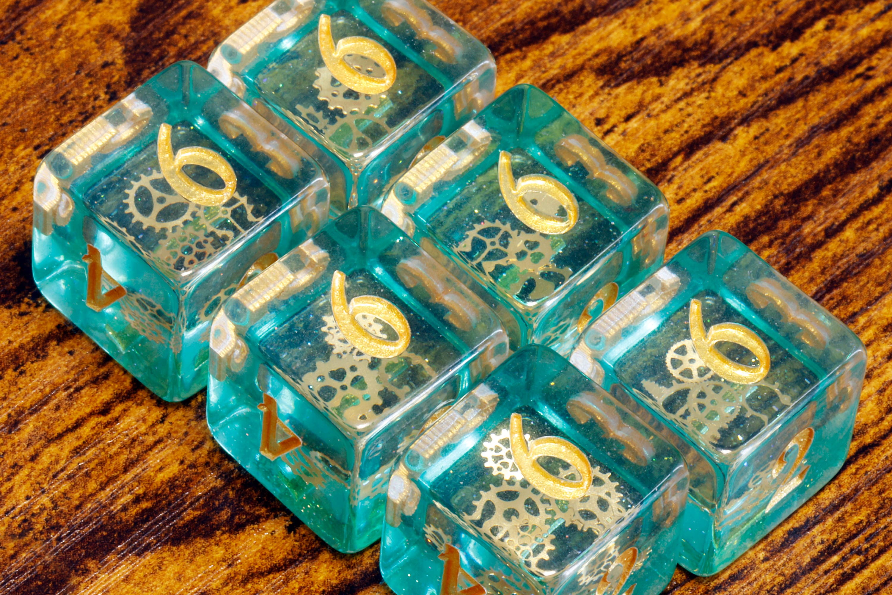 Ethereal Sprockets D6 Dice, Blue green glittery layer with small golden gear inclusions