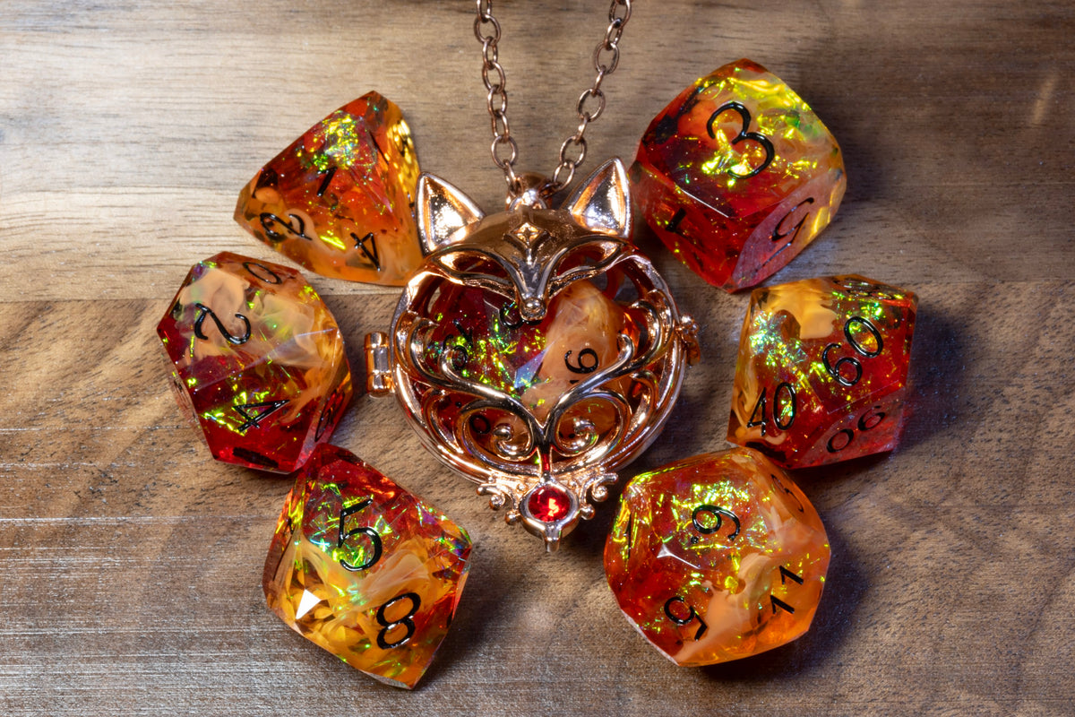 Fox pendant in a copper finish with the Amber Opal dice set on wood