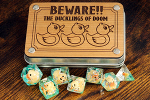 Beware !! The ducklings of doom dice set with metal box