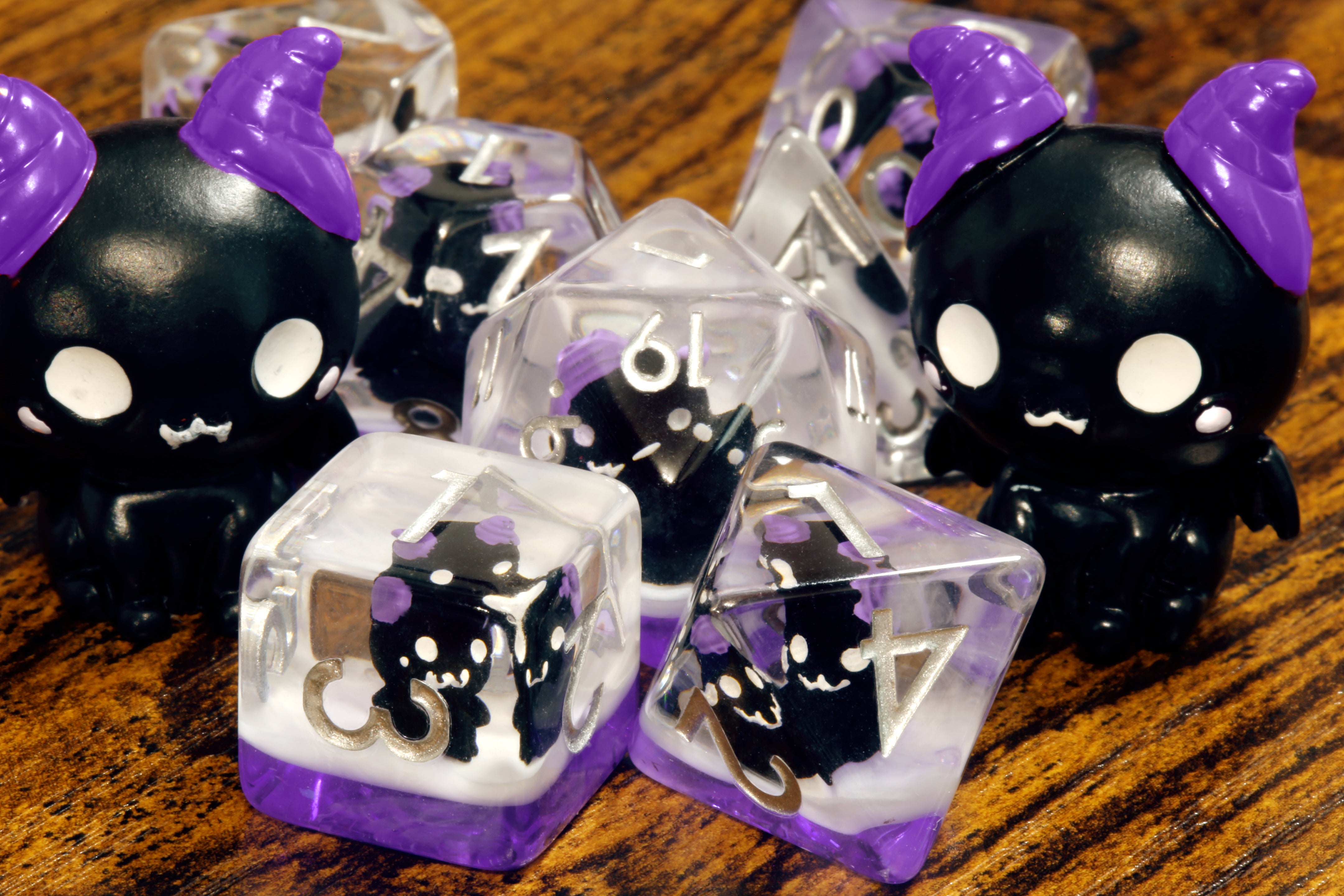 Cats of doom dice set - Dice set with winged cats on an purple layer - The Wizard's Vault