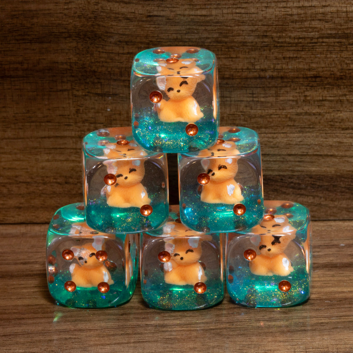 Stacked Fox's Cunning PIP D6 dice with fox cub inclusions on teal glitter
