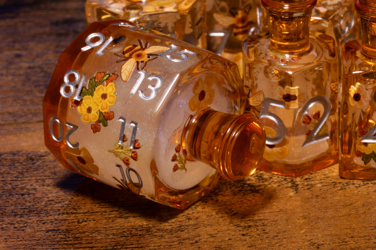 Honey Meadow 7-Piece Liquid Core Potion Dice Set – Amber with Bee & Wildflower Pattern