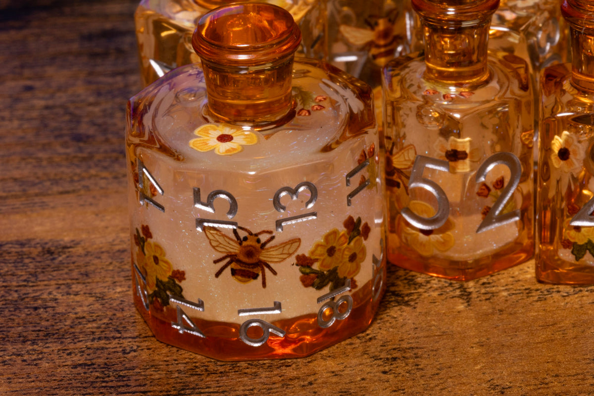 Honey Meadow 7-Piece Liquid Core Potion Dice Set – Amber with Bee & Wildflower Pattern