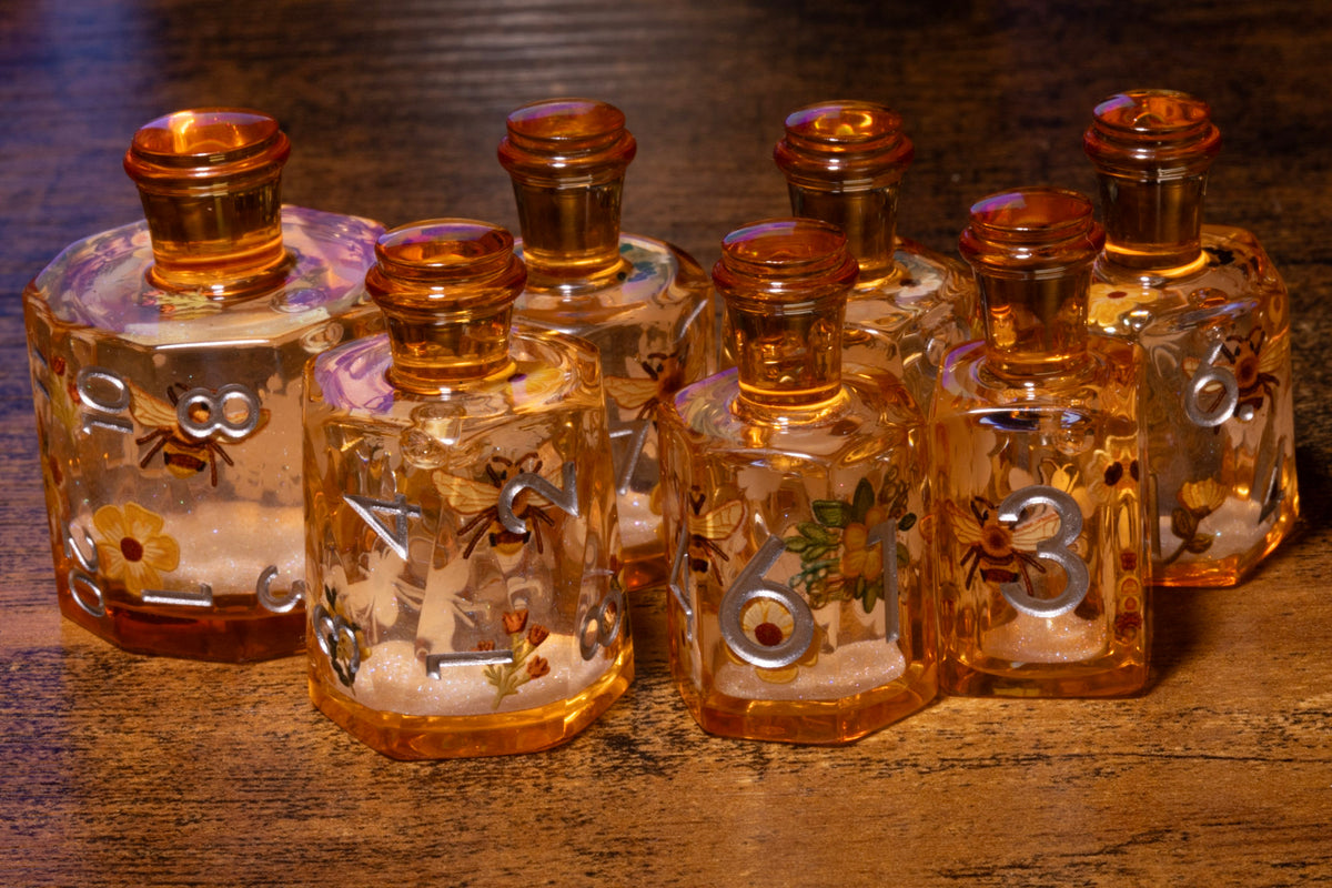 Honey Meadow 7-Piece Liquid Core Potion Dice Set – Amber with Bee & Wildflower Pattern