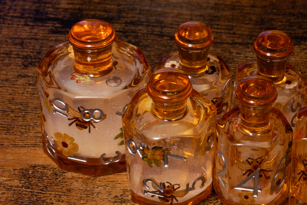 Honey Meadow 7-Piece Liquid Core Potion Dice Set – Amber with Bee & Wildflower Pattern