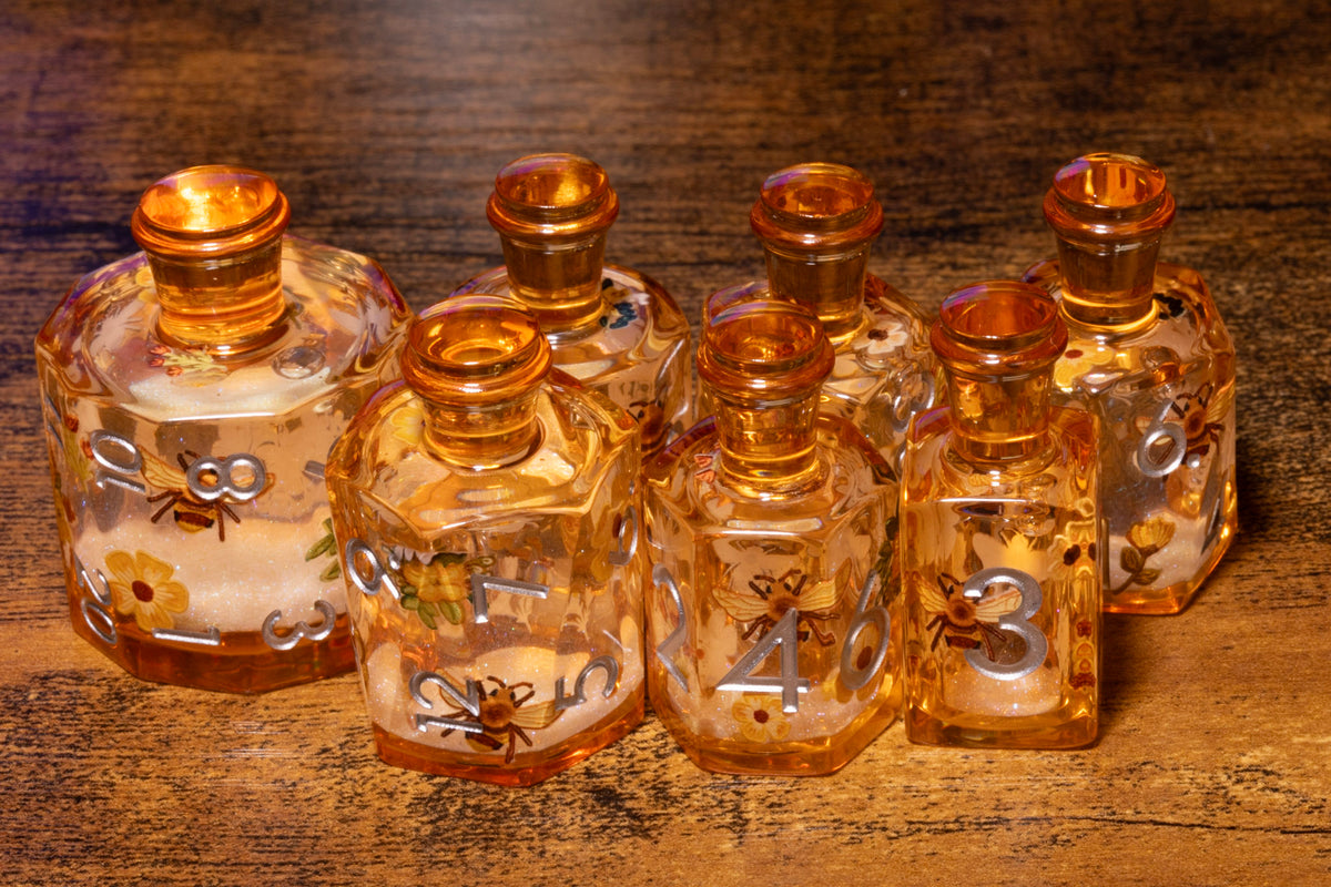 Honey Meadow 7-Piece Liquid Core Potion Dice Set – Amber with Bee & Wildflower Pattern