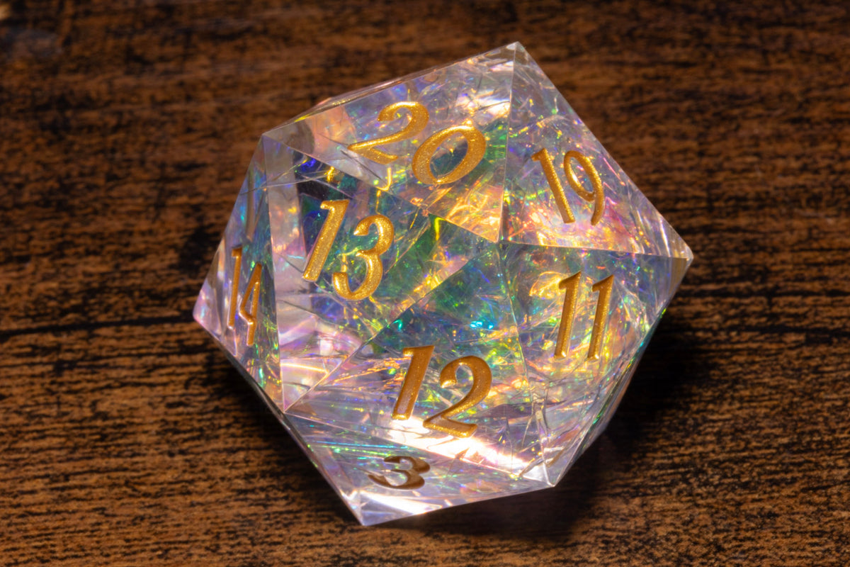 A clear crystal dice with numbers on it, resting on a wooden surface.
