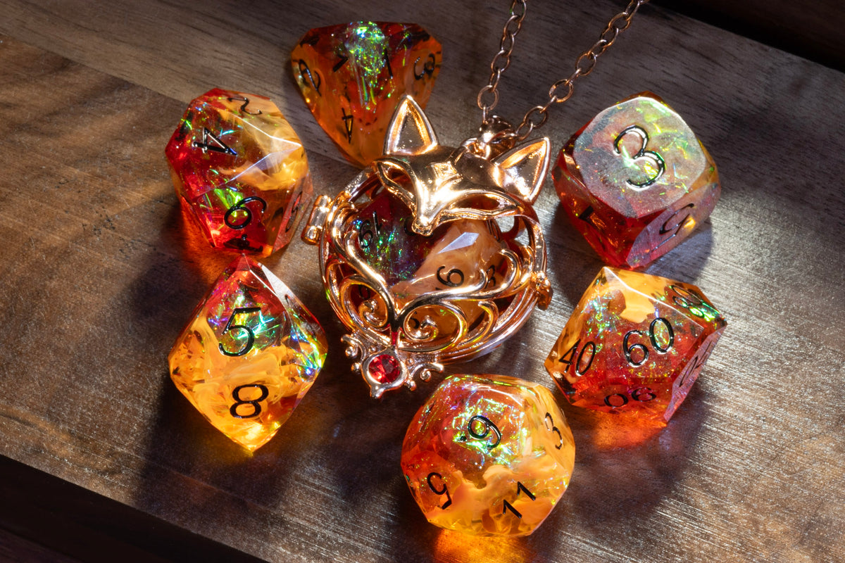 Fox pendant in a copper finish with the Amber Opal dice set on wood