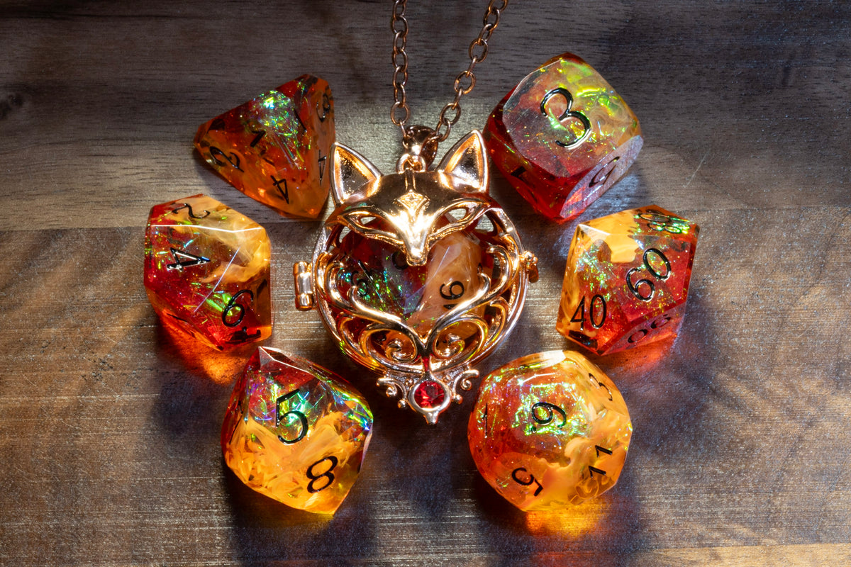 Fox pendant in a copper finish with the Amber Opal dice set on wood