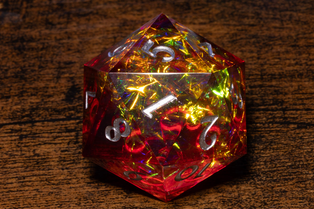 A close-up image of a colorful, glittery, and shiny dice resting on a wooden surface.