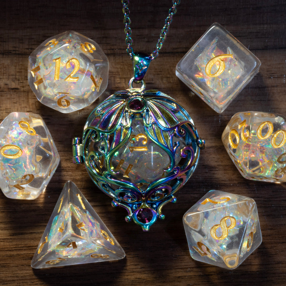 Lunar moth pendant in a rainbow finish holding a Sacred Opal D20, beside the Sacred Opal dice set on wood