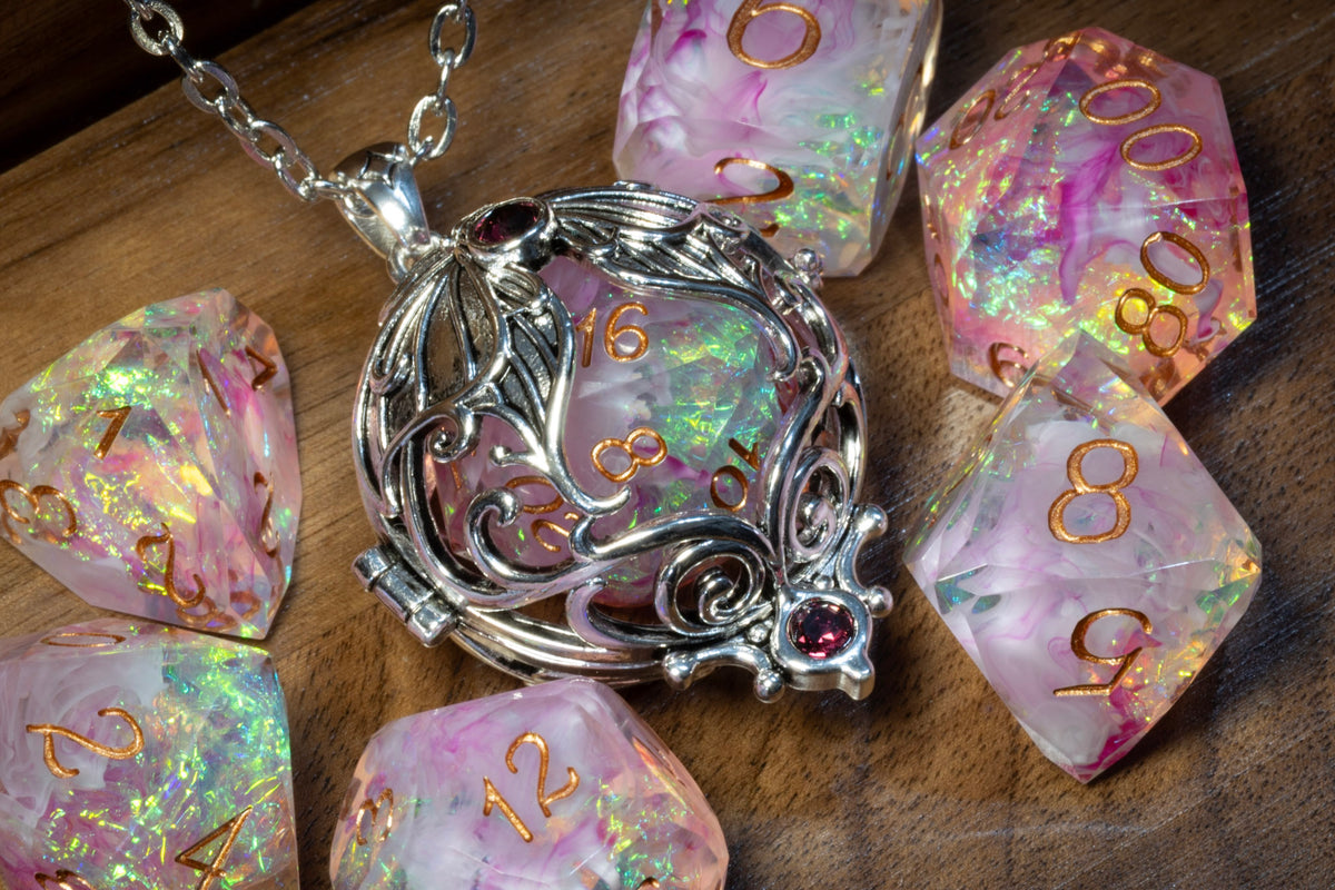 Lunar moth pendant in a silver finish with the Blush Opal dice set on wood