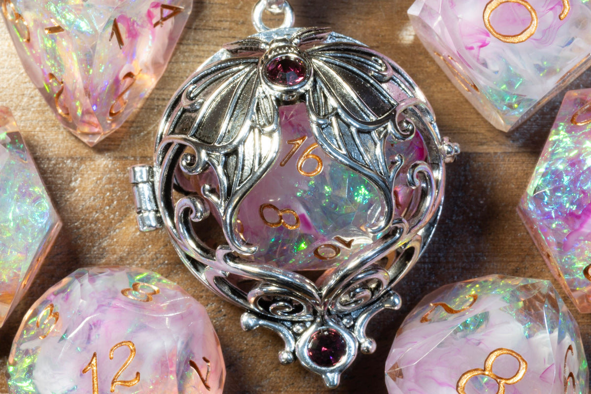 Close-up of the lunar moth pendant in a silver finish holding a Blush Opal D20