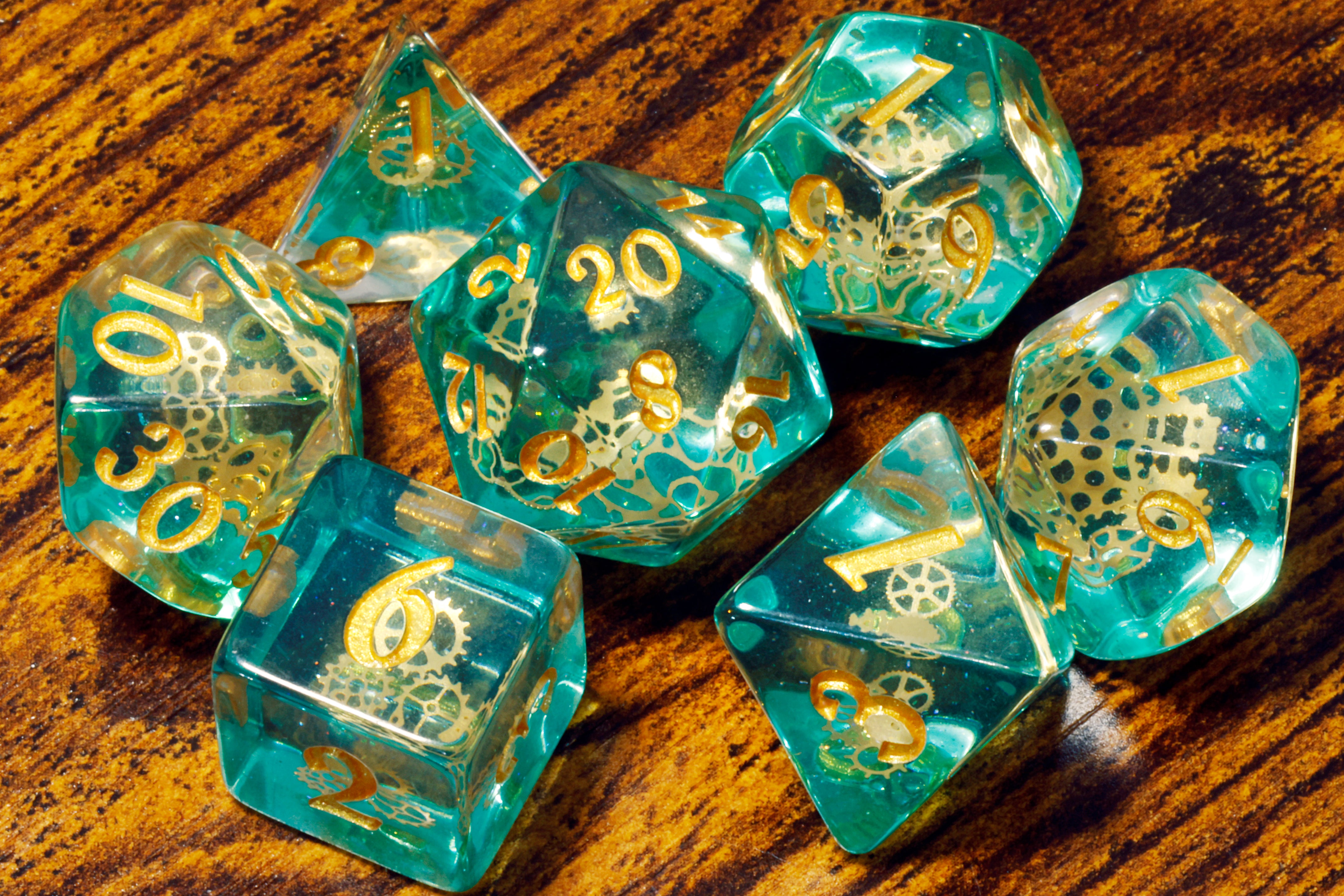 a group of green dices sitting on top of a wooden table