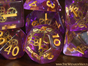 Arcane Sprockets - Dice with tiny golden gears on a purple glittery layer. - The Wizard's Vault