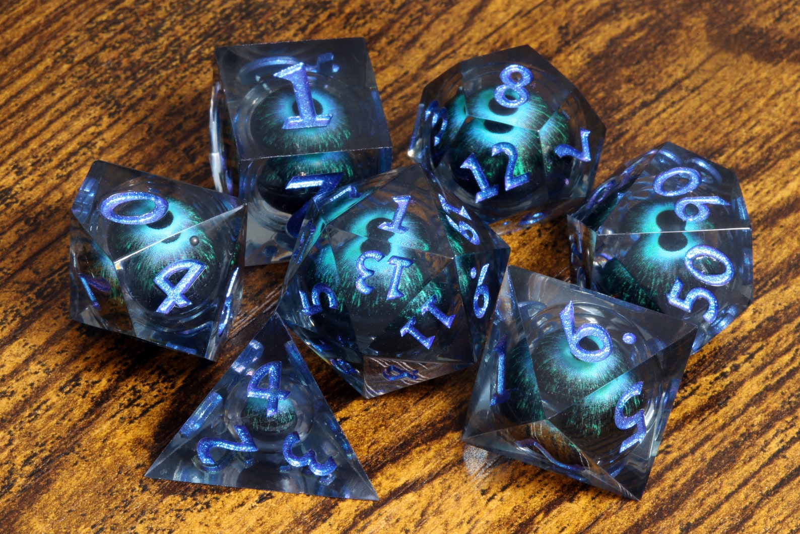 Eye of Veknar dice set - Dark blue Liquid Core sharp edge dice with moving eyes - The Wizard's Vault