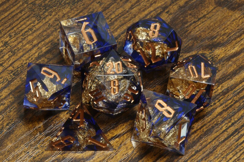 Griffin's Might dice set - Blue feather sharp edge dice set with gold flakes - The Wizard's Vault