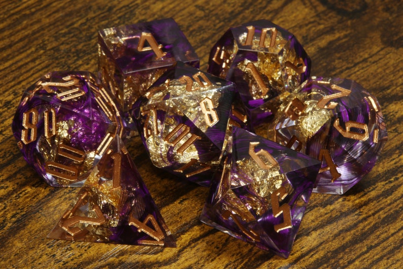 Coualt's Blessing dice set - Purple feather sharp edge dice set with gold flakes - The Wizard's Vault