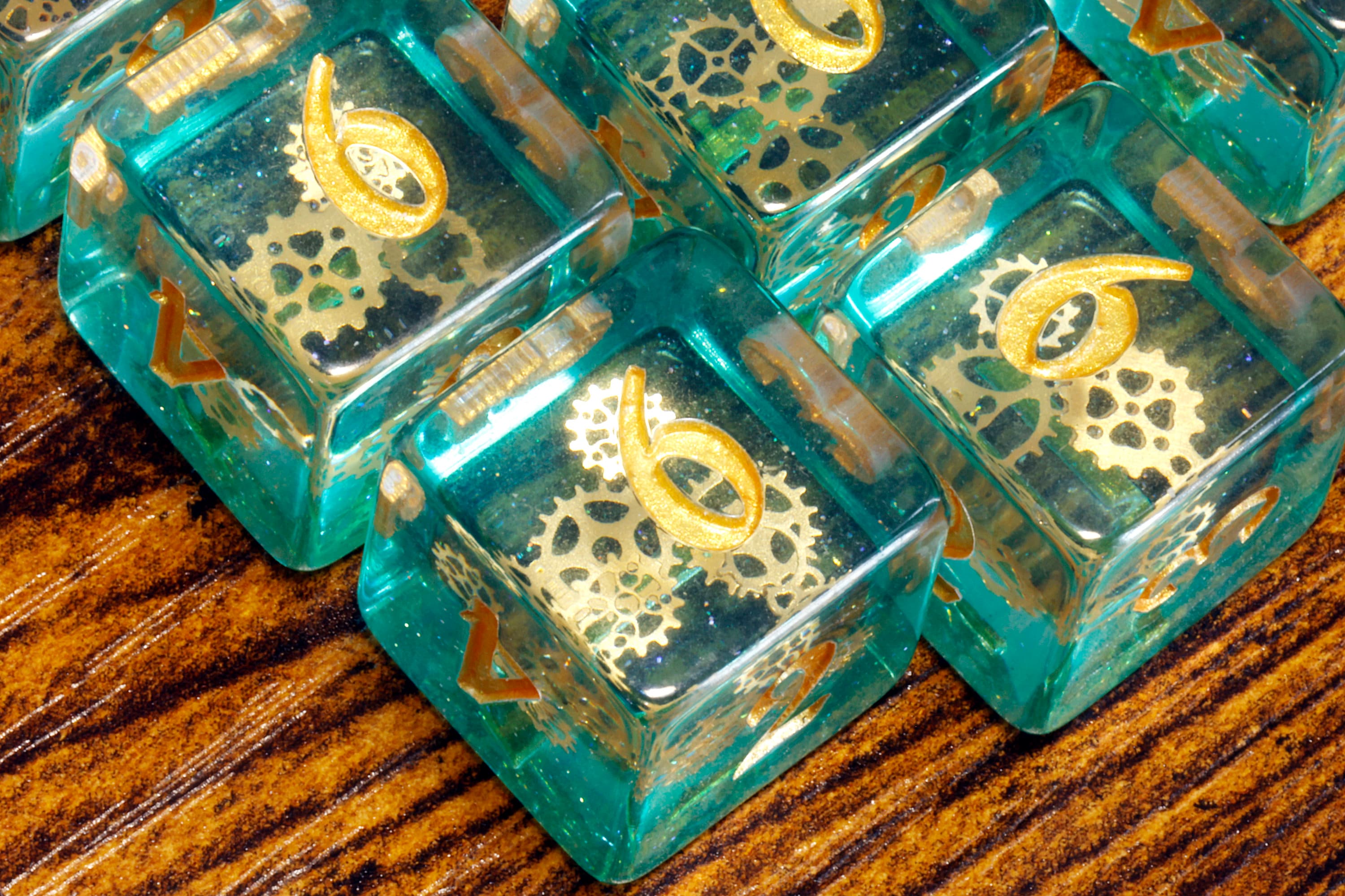 Ethereal Sprockets D6 Dice, Blue green glittery layer with small golden gear inclusions